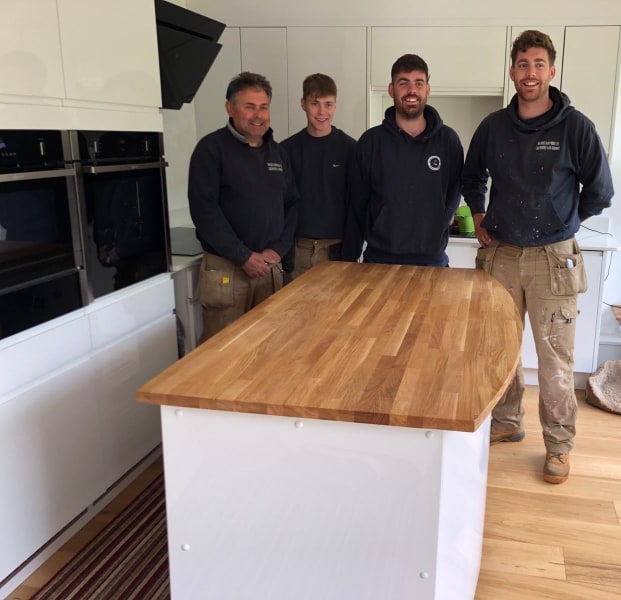the Mandx team stood at a kitchen island